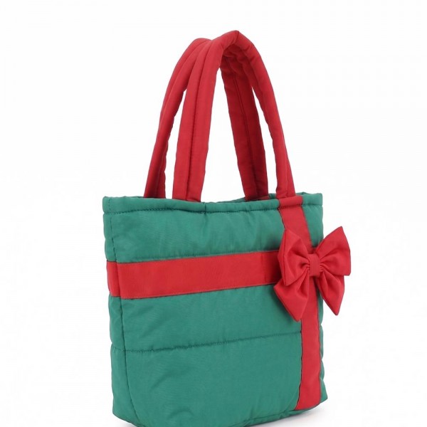 Quilted puffer bag styled like a wrapped present, with a contrast ribbon band and an oversized bow. Sold as a padded tote and a matching zip pouch so she can carry the big one and keep the small one in it. A seasonal carry for boutique buyers stocking hostess gifts, teacher gifts, cookie exchanges, and holiday markets. Puffy quilted bags are light, wipe clean, and ring up as the easy grab and go gift all December.