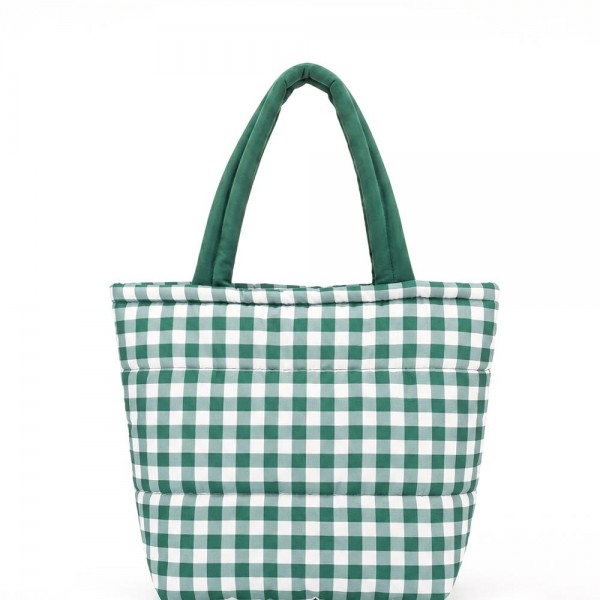 Quilted puffer bag in a checked gingham print with a padded body and matching padded handles. Sold as a padded tote and a matching zip pouch so she can carry the big one and keep the small one in it. A seasonal carry for boutique buyers stocking hostess gifts, teacher gifts, cookie exchanges, and holiday markets. Puffy quilted bags are light, wipe clean, and ring up as the easy grab and go gift all December.