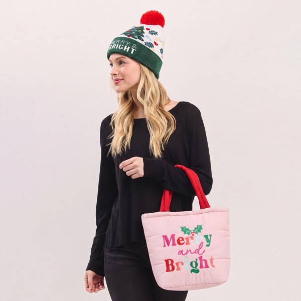 Quilted puffer bag with a padded body and an embroidered holiday greeting across the front. Sold as a padded tote and a matching zip pouch so she can carry the big one and keep the small one in it. A seasonal carry for boutique buyers stocking hostess gifts, teacher gifts, cookie exchanges, and holiday markets. Puffy quilted bags are light, wipe clean, and ring up as the easy grab and go gift all December.