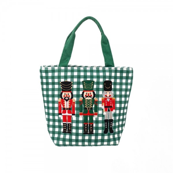 Gingham canvas tote with an embroidered nutcracker trio and contrast webbing handles. Roomy open top carries a wrapped gift, a bottle of wine, or a stack of cookies to the party, and the flat base keeps it upright on a counter. A seasonal carry for boutique buyers stocking hostess gifts, teacher gifts, cookie exchanges, and holiday markets. Embroidered gingham totes double as the gift and the wrapping, which is why they sell out every December.