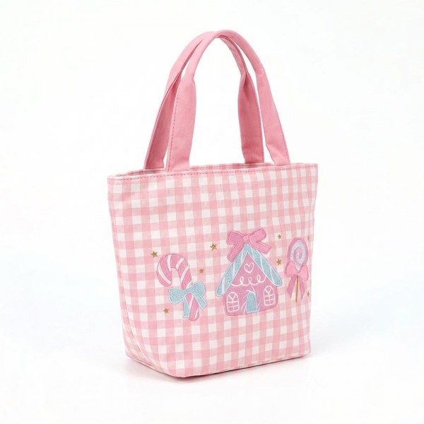 Gingham canvas tote with an embroidered candy house and lollipop scene and contrast webbing handles. Roomy open top carries a wrapped gift, a bottle of wine, or a stack of cookies, and the flat base keeps it upright on a counter. A seasonal carry for boutique buyers stocking hostess gifts, teacher gifts, cookie exchanges, and holiday markets. Embroidered gingham totes double as the gift and the wrapping, which is why they sell out every December.