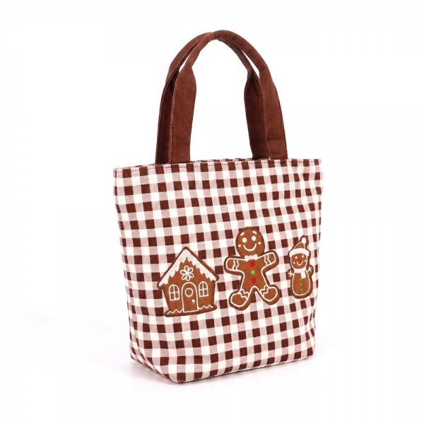 Gingham canvas tote with an embroidered gingerbread scene and contrast webbing handles. Roomy open top carries a wrapped gift, a bottle of wine, or a stack of cookies to the party, and the flat base keeps it upright on a counter. A seasonal carry for boutique buyers stocking hostess gifts, teacher gifts, cookie exchanges, and holiday markets. Embroidered gingham totes double as the gift and the wrapping, which is why they sell out every December.