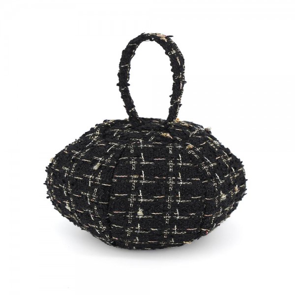 Tweed ball bag with a matching round top handle and a hidden zip closure. Rounded dome shape sits upright on a shelf and holds a phone, cards, and a lipstick for a night out. A dressed up piece for boutique buyers stocking holiday parties, weddings, showers, and gallery nights. Sculptural tweed bags stop customers at the display and sell as a gift or a treat.