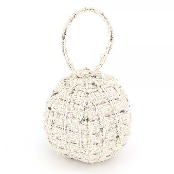 Tweed ball bag with a matching round top handle and a hidden zip closure. Rounded dome shape sits upright on a shelf and holds a phone, cards, and a lipstick for a night out. A dressed up piece for boutique buyers stocking holiday parties, weddings, showers, and gallery nights. Sculptural tweed bags stop customers at the display and sell as a gift or a treat.