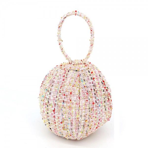 Tweed ball bag with a matching round top handle and a hidden zip closure. Rounded dome shape sits upright on a shelf and holds a phone, cards, and a lipstick for a night out. A dressed up piece for boutique buyers stocking holiday parties, weddings, showers, and gallery nights. Sculptural tweed bags stop customers at the display and sell as a gift or a treat.