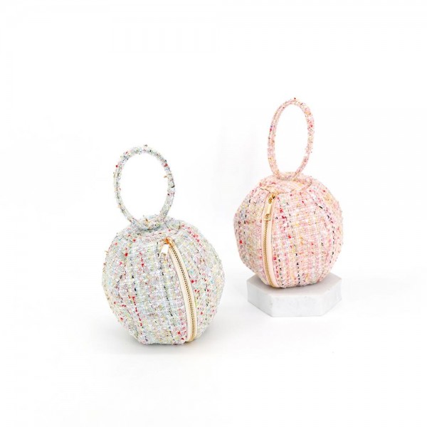 Tweed ball bag with a matching round top handle and a hidden zip closure. Rounded dome shape sits upright on a shelf and holds a phone, cards, and a lipstick for a night out. A dressed up piece for boutique buyers stocking holiday parties, weddings, showers, and gallery nights. Sculptural tweed bags stop customers at the display and sell as a gift or a treat.
