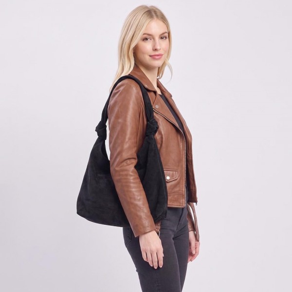 Suede shoulder bag with a soft slouch body, wide strap, and a clean minimal front. Roomy main compartment holds a wallet, phone, and sunglasses without looking bulky under the arm. An everyday carry for boutique buyers stocking travel, campus, farmers markets, and weekend errands. Soft suede shoulder bags are the shape customers come back for in every neutral.