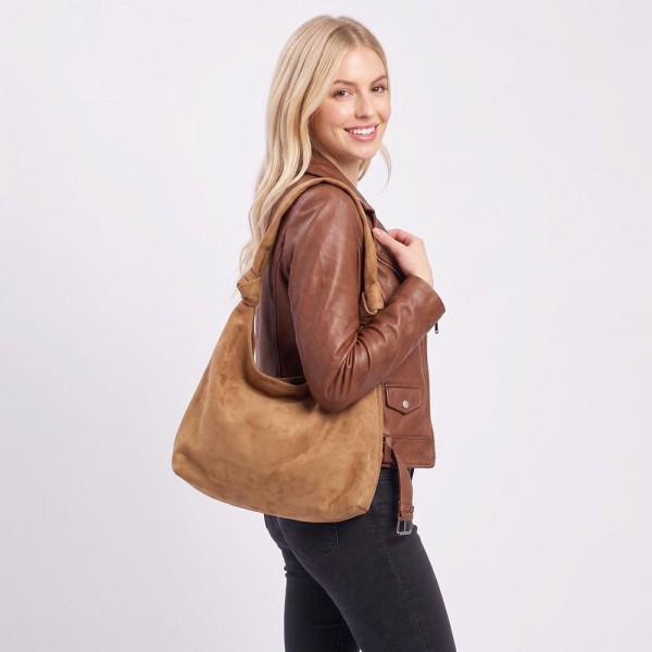 Suede shoulder bag with a soft slouch body, wide strap, and a clean minimal front. Roomy main compartment holds a wallet, phone, and sunglasses without looking bulky under the arm. An everyday carry for boutique buyers stocking travel, campus, farmers markets, and weekend errands. Soft suede shoulder bags are the shape customers come back for in every neutral.