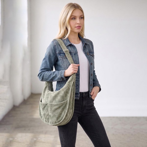 Slouchy suede hobo bag with a wide adjustable strap and a soft unstructured body. Roomy main compartment swallows a wallet, sunglasses, and a water bottle, and the pillow soft body sits close without pulling at the shoulder. An everyday carry for boutique buyers stocking travel, campus, farmers markets, and weekend errands. Soft hobo bags are the shape customers come back for, and the neutral run sells across every outfit.