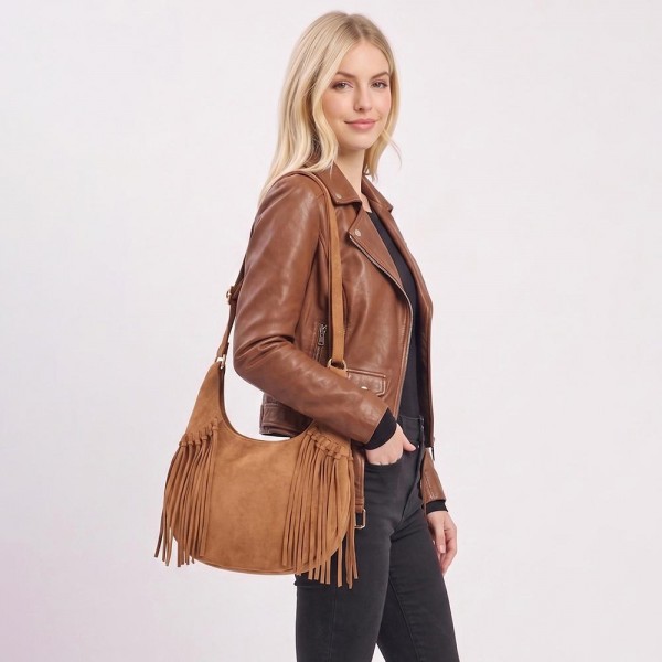 Fringe hobo bag in a soft vegan suede with a slouchy crescent body and a long shoulder strap. Roomy enough for a wallet, sunglasses, and a water bottle, with fringe along the base that moves as she walks. A western leaning piece for boutique buyers stocking concerts, rodeos, festivals, and fall travel. Fringe bags are the accessory customers photograph, and they reorder every fall.