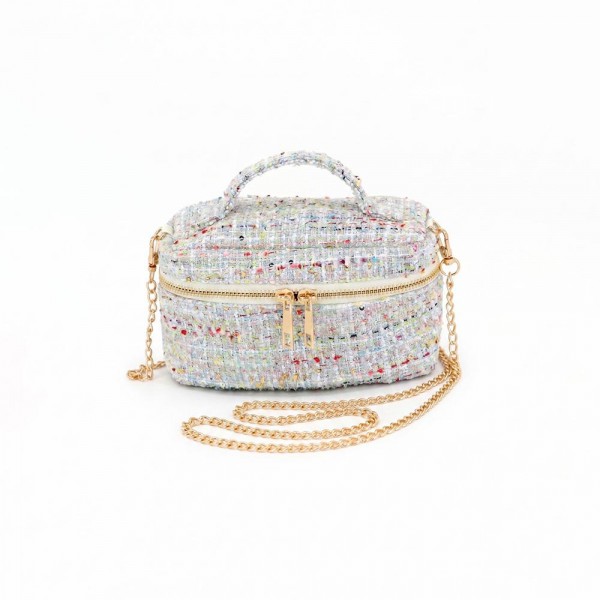 Tweed vanity box bag with a gold tone chain strap, top zip closure, and a knotted top handle. Structured oval shape holds its form on a shelf and opens flat for a phone, cards, and a lipstick. A dressed up piece for boutique buyers stocking holiday parties, weddings, showers, and gallery nights. Structured tweed bags photograph beautifully and sell as the gift a customer keeps for herself.