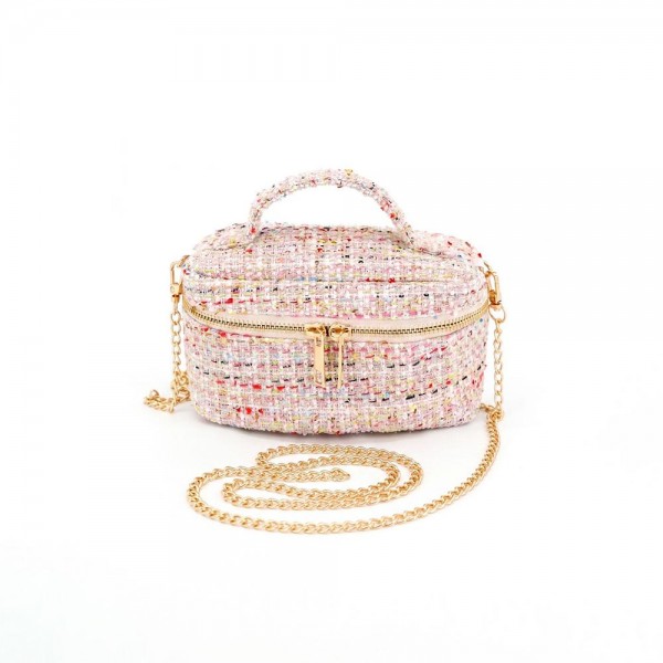 Tweed vanity box bag with a gold tone chain strap, top zip closure, and a knotted top handle. Structured oval shape holds its form on a shelf and opens flat for a phone, cards, and a lipstick. A dressed up piece for boutique buyers stocking holiday parties, weddings, showers, and gallery nights. Structured tweed bags photograph beautifully and sell as the gift a customer keeps for herself.