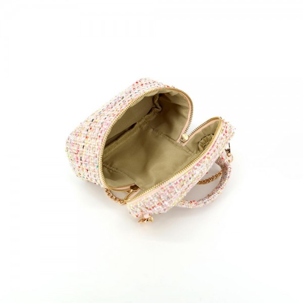 Tweed vanity box bag with a gold tone chain strap, top zip closure, and a knotted top handle. Structured oval shape holds its form on a shelf and opens flat for a phone, cards, and a lipstick. A dressed up piece for boutique buyers stocking holiday parties, weddings, showers, and gallery nights. Structured tweed bags photograph beautifully and sell as the gift a customer keeps for herself.
