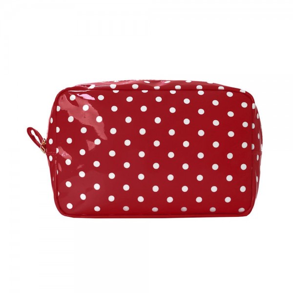Coated polka dot cosmetic pouch with a wide zip top opening and a side pull tab that makes it easy to grab out of a bag. The flat base lets it sit open on a counter so nothing has to be dumped out to find a lipstick. Wipeable inside and out, which keeps it looking new after a season of daily use. A true impulse price accessory that customers buy two or three at a time.