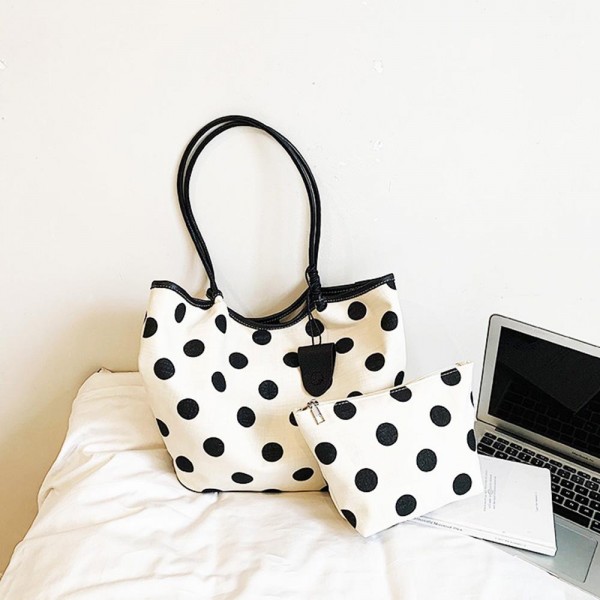 Polka Dot Tote Bag with a roomy interior, sturdy shoulder handles, and a matching pouch for keeping small essentials organized. The bold dotted print gives a playful, retro feel that brightens up workdays, weekend market runs, and quick getaways. Lightweight yet structured enough to hold its shape when packed. A two piece set at a friendly price, this tote makes an easy gift and a fun statement piece for any boutique bag display.