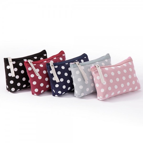 Polka Dot Zip Cosmetic Pouch in a coated canvas with a classic dot print, contrast zipper trim, and an easy grab pull tab. The slim, flat bottom shape slips into any purse or carry on and holds makeup, pens, earbuds, and other small essentials. The wipe clean finish keeps it looking fresh trip after trip. A sweet everyday organizer and an easy gift with purchase or stocking stuffer for boutique shoppers.