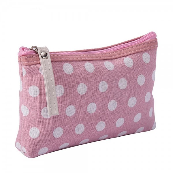 Polka Dot Zip Cosmetic Pouch in a coated canvas with a classic dot print, contrast zipper trim, and an easy grab pull tab. The slim, flat bottom shape slips into any purse or carry on and holds makeup, pens, earbuds, and other small essentials. The wipe clean finish keeps it looking fresh trip after trip. A sweet everyday organizer and an easy gift with purchase or stocking stuffer for boutique shoppers.