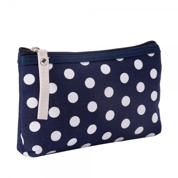 Polka Dot Zip Cosmetic Pouch in a coated canvas with a classic dot print, contrast zipper trim, and an easy grab pull tab. The slim, flat bottom shape slips into any purse or carry on and holds makeup, pens, earbuds, and other small essentials. The wipe clean finish keeps it looking fresh trip after trip. A sweet everyday organizer and an easy gift with purchase or stocking stuffer for boutique shoppers.
