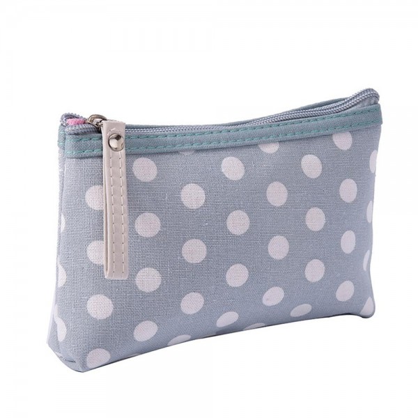 Polka Dot Zip Cosmetic Pouch in a coated canvas with a classic dot print, contrast zipper trim, and an easy grab pull tab. The slim, flat bottom shape slips into any purse or carry on and holds makeup, pens, earbuds, and other small essentials. The wipe clean finish keeps it looking fresh trip after trip. A sweet everyday organizer and an easy gift with purchase or stocking stuffer for boutique shoppers.