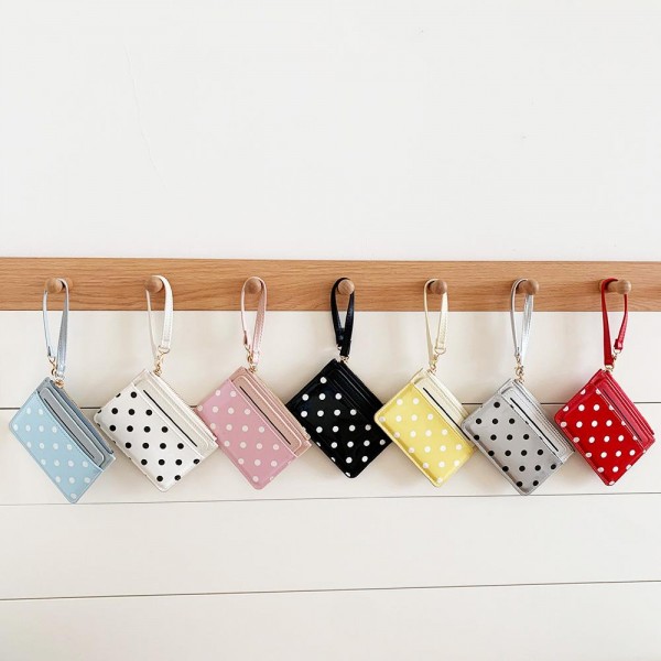 Polka Dot Wristlet Card Wallet with a glossy dot print front, a quick access card slot, and a zip top pocket for cash, coins, and keys. The attached wrist strap keeps it handy for school pickup, the gym, or a quick coffee run when a full purse is too much. Slim enough to tuck into any tote or backpack. An easy impulse buy and stocking stuffer that sells all year at the register.