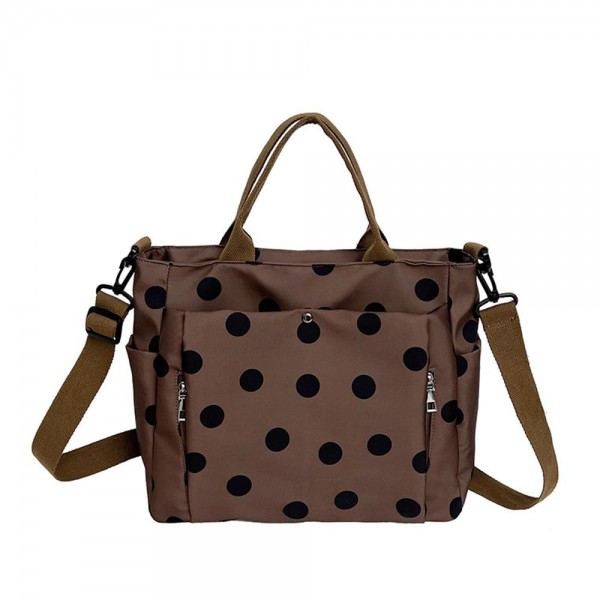 Polka Dot Nylon Crossbody Tote with dual top handles, an adjustable shoulder strap, and plenty of exterior pockets for a phone, water bottle, and keys. The lightweight fabric and roomy interior make it a smart pick for travel days, sports practice, errands, and diaper bag duty. Carry it by hand or wear it crossbody when you need to stay hands free. A practical, playful bag that busy moms and teachers love, priced to move quickly.