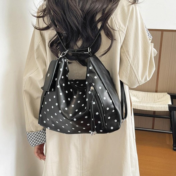 Polka Dot Convertible Hobo Backpack in soft faux leather with a slouchy silhouette, sturdy top handle, and adjustable straps that switch it to a hands free backpack in seconds. A side zip pocket with a tassel pull and a matching mini card pouch keep keys, cards, and lip balm within easy reach. Carry it to work, class, or on a weekend getaway. A versatile two in one bag that gives shoppers more style for their money and sells through quickly.