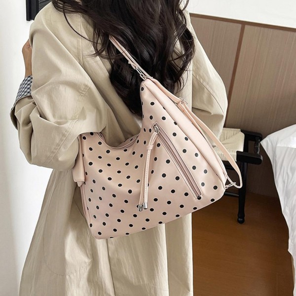 Polka Dot Convertible Hobo Backpack in soft faux leather with a slouchy silhouette, sturdy top handle, and adjustable straps that switch it to a hands free backpack in seconds. A side zip pocket with a tassel pull and a matching mini card pouch keep keys, cards, and lip balm within easy reach. Carry it to work, class, or on a weekend getaway. A versatile two in one bag that gives shoppers more style for their money and sells through quickly.