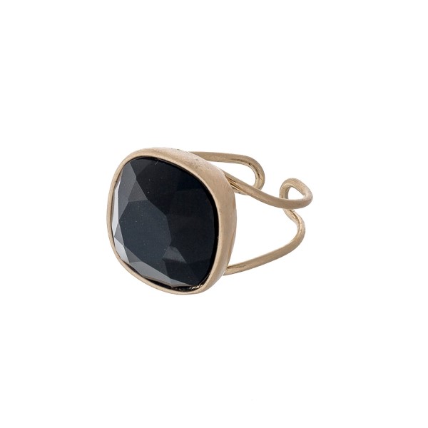 Gold tone adjustable ring with a faceted black stone. 