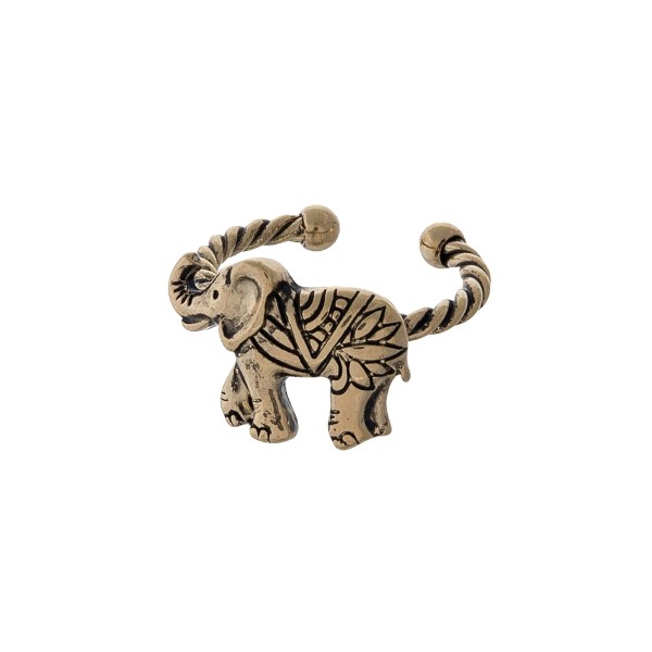 Gold tone twisted metal adjustable ring displaying an elephant. 