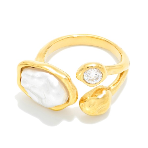 Baroque Pearl Open Ring featuring an organic faux pearl, a bezel set cubic zirconia, and a polished nugget accent on an adjustable open band. The sculptural, mixed element design makes a modern statement on its own or stacked with simple bands. Adjustable sizing fits most fingers, which makes it an easy gift. Artful statement rings like this bring a high end look to any boutique jewelry case at an approachable price.