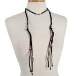 Black suede wrap necklace with gold tone hardware. Approximately 32" in length. 