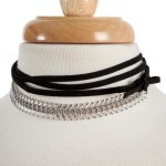 Black suede wrap choker necklace with a silver tone front. Approximately 80" in length. 