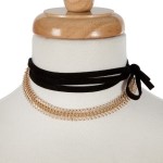 Black suede wrap necklace with a gold tone choker. Approximately 70" in length. 