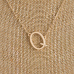 Gold metal necklace featuring the initial "Q". Approximately 16" in length.