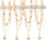 Layered Chain Link Necklace Featuring Pitted Metal Charm With Daisy and Pearl Details

- Approximately 16" L
- Extender 3" L