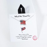 Dainty Chain Link Necklace Featuring Enamel American Flag Pendant 				
					
- Approximately 16" L					
- Extender 2" L					
- Made in Korea					
- Hypoallergenic Brass Base					
- 18K Gold Dipped	
				
- Card: "When we honor our flag, we honor what we stand for as a Nation- freedom, equality, justice, and Hope." - Ronald Reagan 				