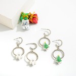 Twisted Silver Tone Huggie Hoop Drop Earrings Featuring Enamel Christmas Tree Charms.

- Approximately 1.25" L