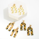 Acetate Sunflower Print Arch Drop Earrings Featuring Gold Tone Sunflower Stud Accents.

- Approximately 2" L