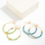 Beaded Wire Hoop Drop Earrings Featuring Gold Tone Bead Accents.

- Approximately 2" L