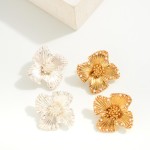 Metal Tone Flower Stud Earrings With Pearl Border Detail

- Approximately 1" W