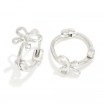 Metal Tone Huggie Hoops With Bow Detail 

- Approximately .5" D 