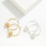 Brass Hoop Earrings With Dimpled Knot Charm Detail

- Brass Base
- Approximately 