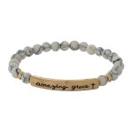 Beaded stretch bracelet with a bar focal, stamped with "amazing grace."