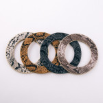 Soft bendable faux leather snakeskin disc bracelet. Approximately 3" in diameter. Fits up to a 6" wrist. 