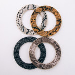 Soft bendable faux leather snakeskin disc bracelet. Approximately 3" in diameter. Fits up to a 6" wrist. 