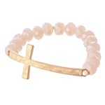 Facet Beaded Stretch Bracelet Featuring an East West Cross Focal. 

- Approximately 3" Diameter 