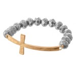 Facet Beaded Stretch Bracelet Featuring an East West Cross Focal. 

- Approximately 3" Diameter 