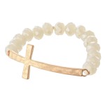 Facet Beaded Stretch Bracelet Featuring an East West Cross Focal. 

- Approximately 3" Diameter 