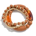 Set of Three Beaded Stretch Bracelets Featuring Wood and Acrylic Tube Beads With Gold Tone Accents.

- Approximately 2.5" Diameter