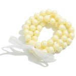 Set of Three Pearlescent Beaded Stretch Bracelets With Tied Bow Detail

- Approximately 2.5" D